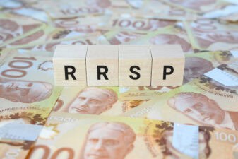RRSP (Registered Retirement Savings Plan) on wooden blocks and Canadian one hundred dollar bills.